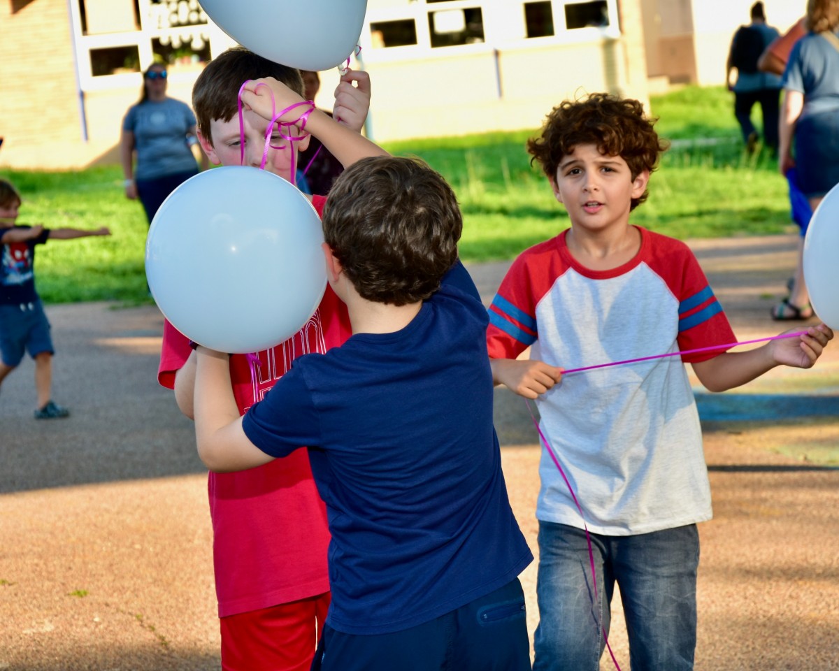 Students Playing with Moon Balloons